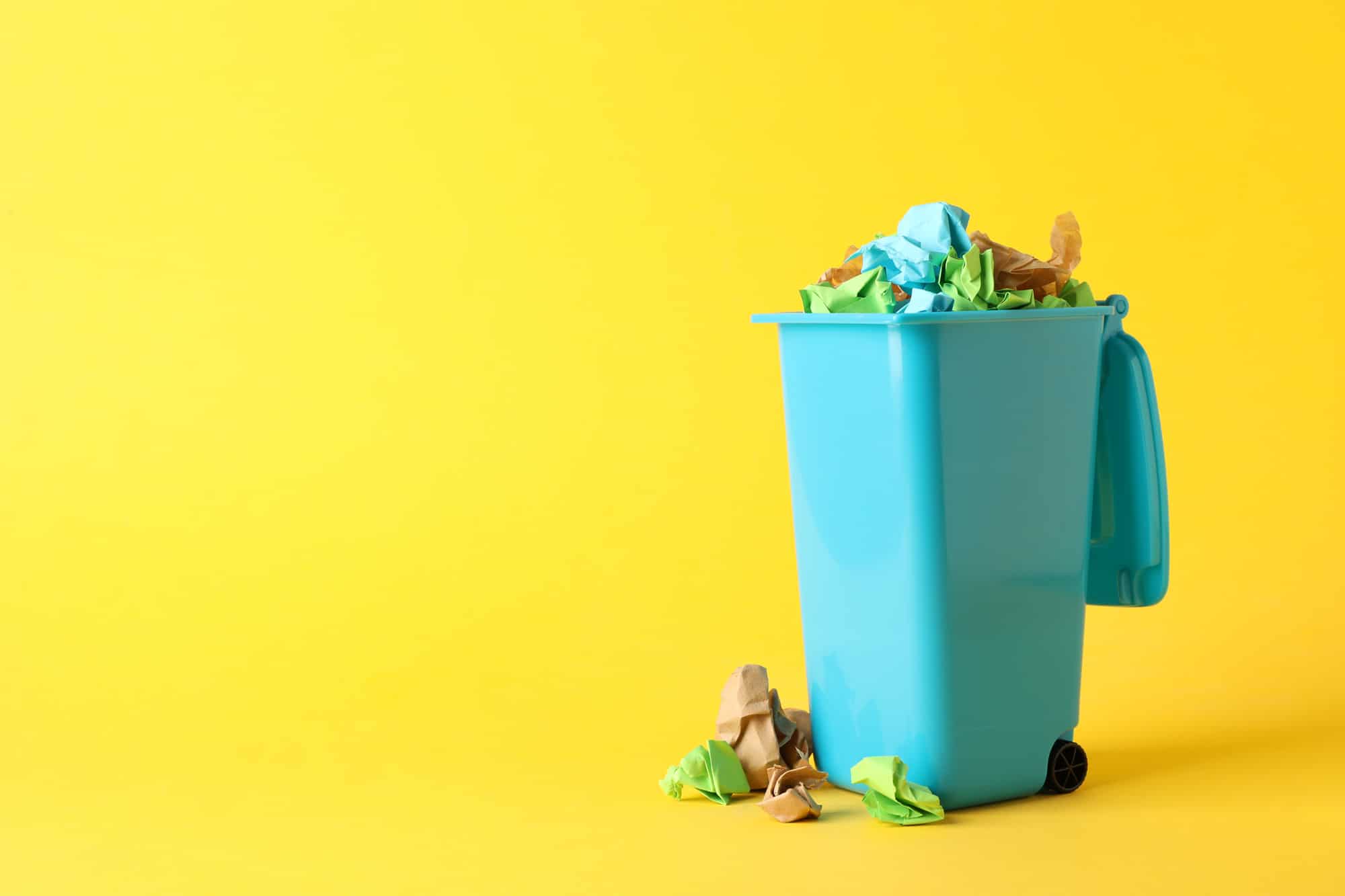 recycle-bin-with-trash-on-yellow-background-space-2021-09-02-22-16-12-utc_2000